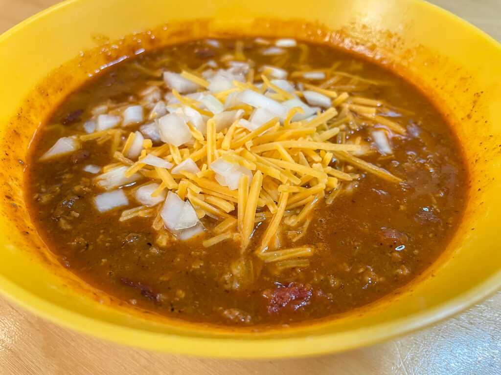 Bowl of Chili w/Chopped Onions and Shredded Cheddar Cheese
