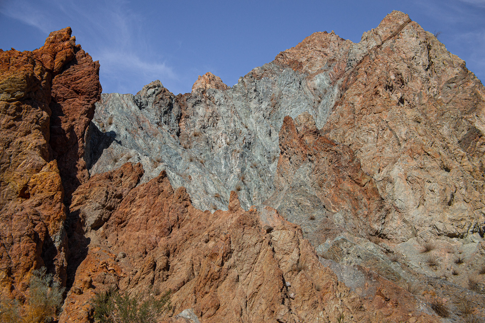 Jagged red, tan, and gray rock formations in the Mecca Hills of Southern California.