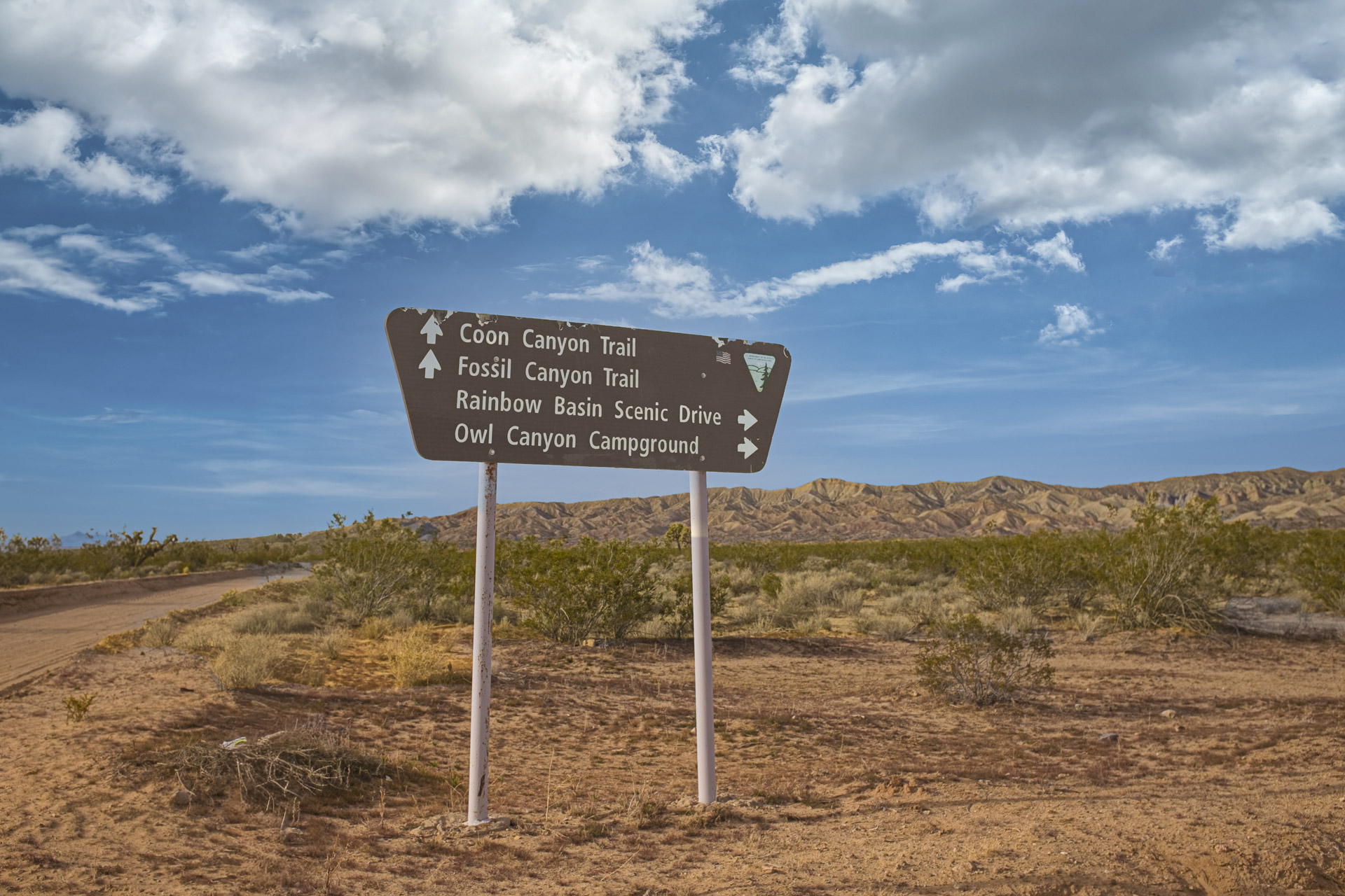 Desert directional sign at Rainbow Basin Natural Area near Barstow, California.