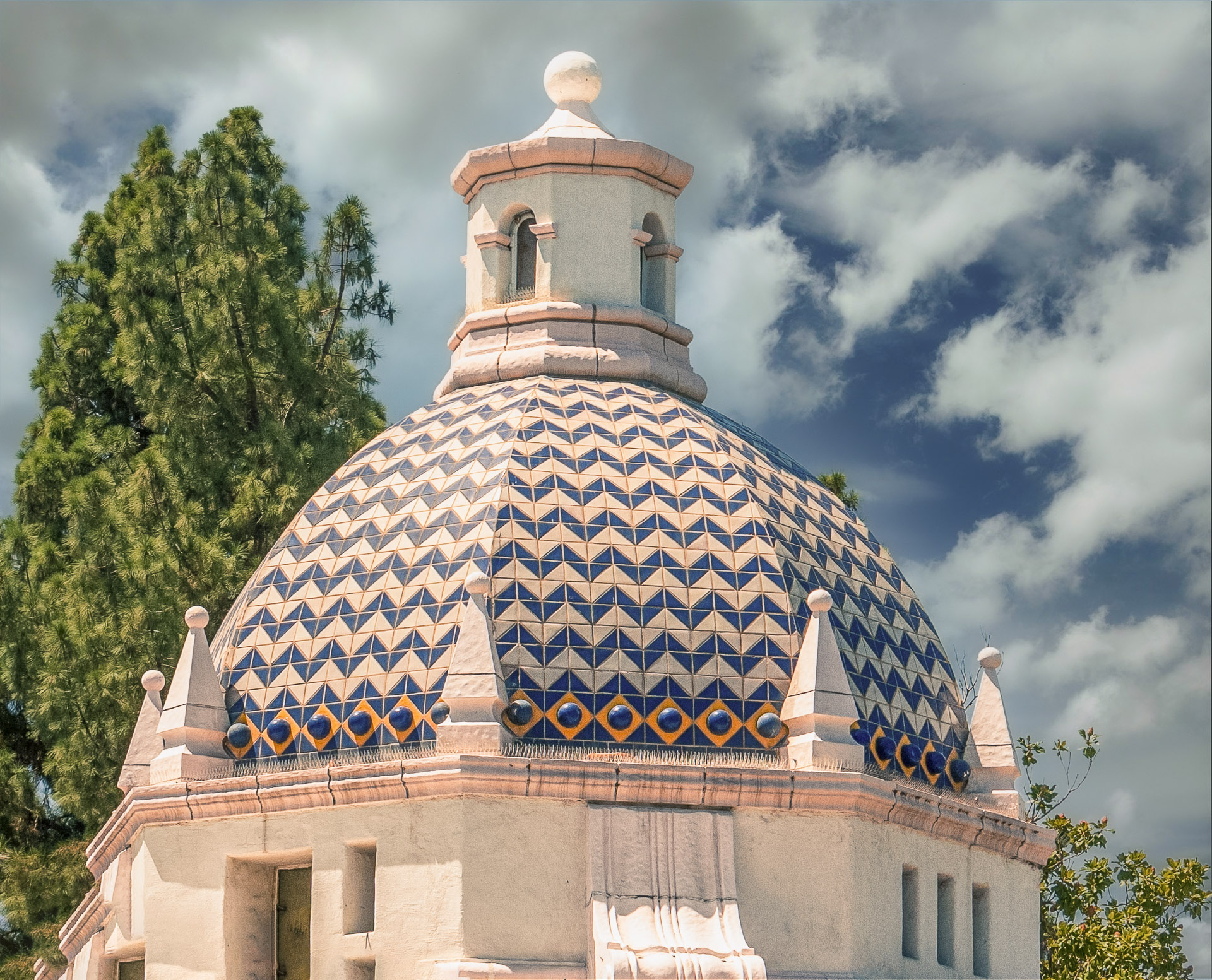 Blue-and-cream tiled dome of the historic Redlands Post Office beneath a cloudy sky.